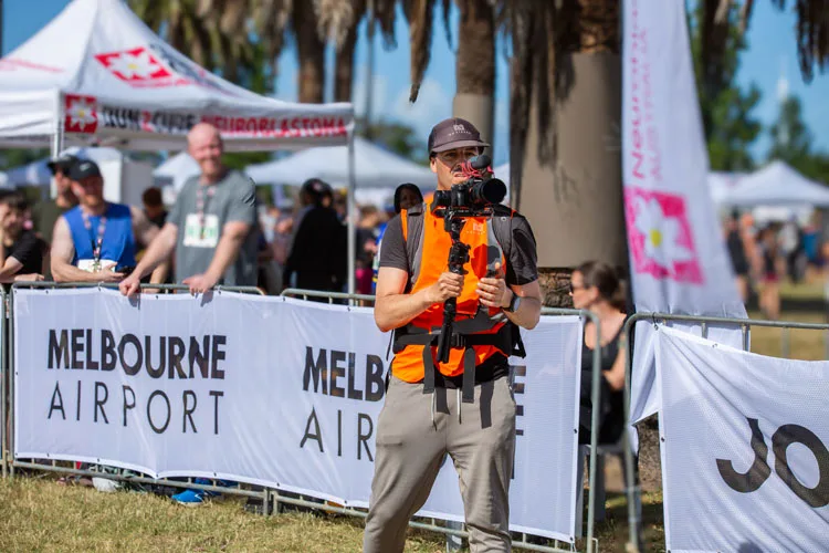 Moises navarro camera man recording an event in Albert park